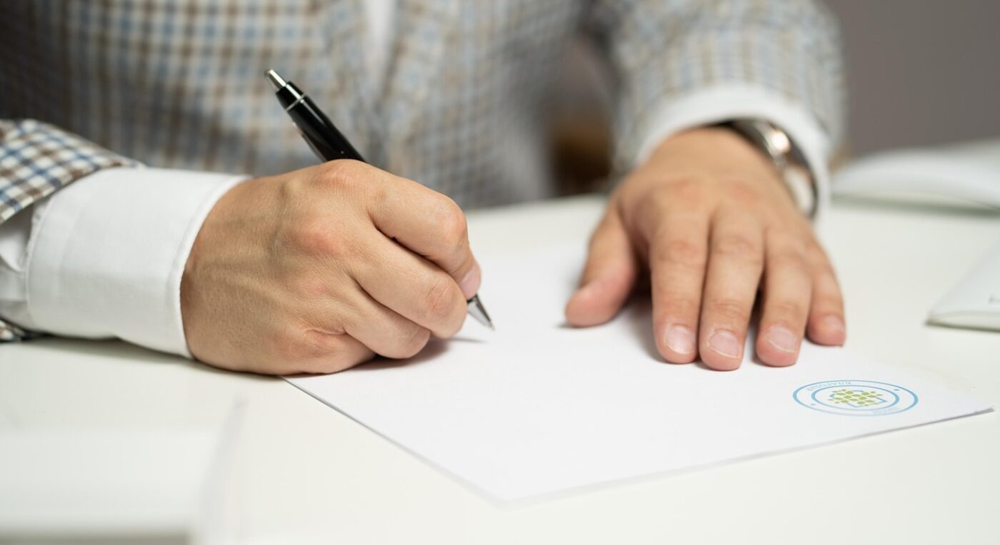 An attorney and client completing an agreement — contingency matters need billing that tracks work without hourly invoices