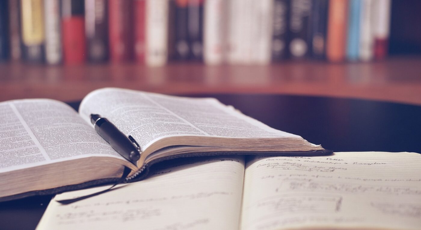 A row of law books beside an open laptop — the best legal billing software blends legal-specific features with everyday usability