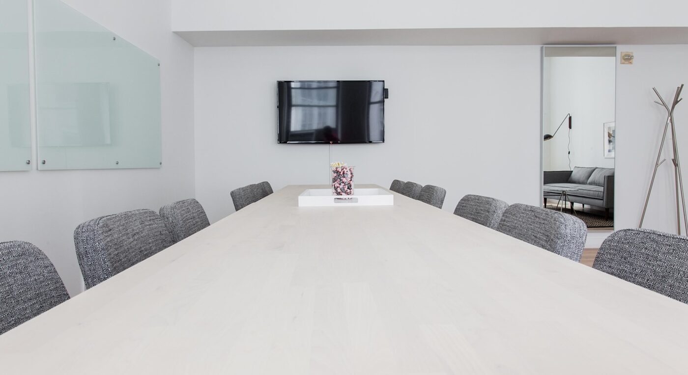 Two colleagues weighing billing platform options across the table — pricing philosophy shapes the entire comparison