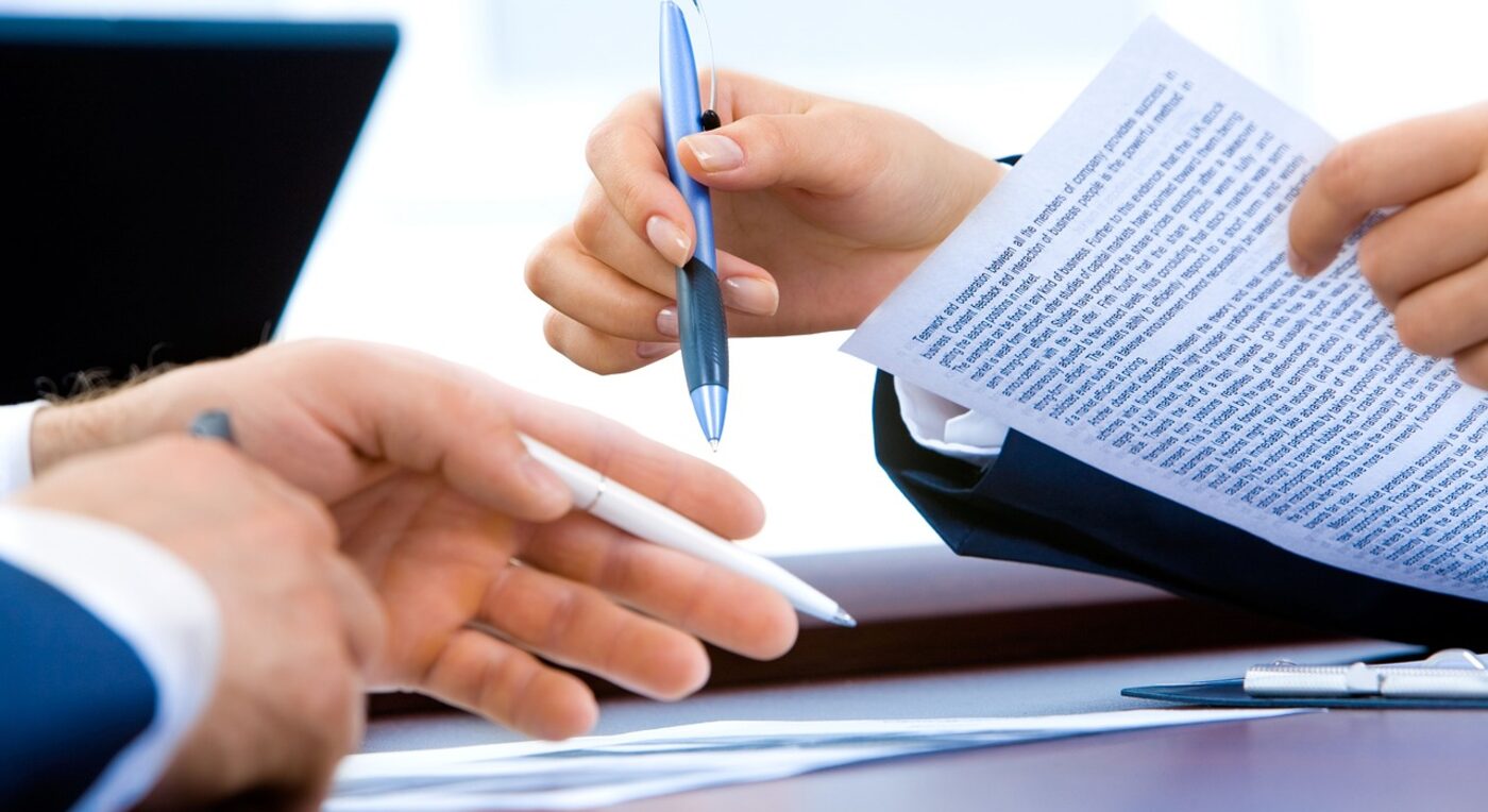 A lawyer reviewing pricing documents at the desk — flat-rate pricing keeps the Time59 cost equation simple to evaluate