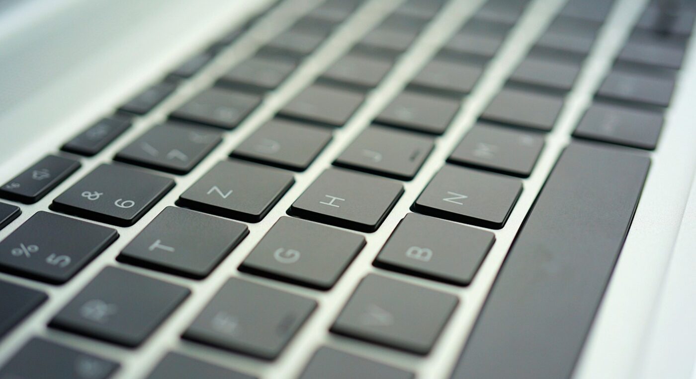 Hands typing an invoice on a laptop beside case documents — the billing workflow is where TimeSolv and Time59 differ most
